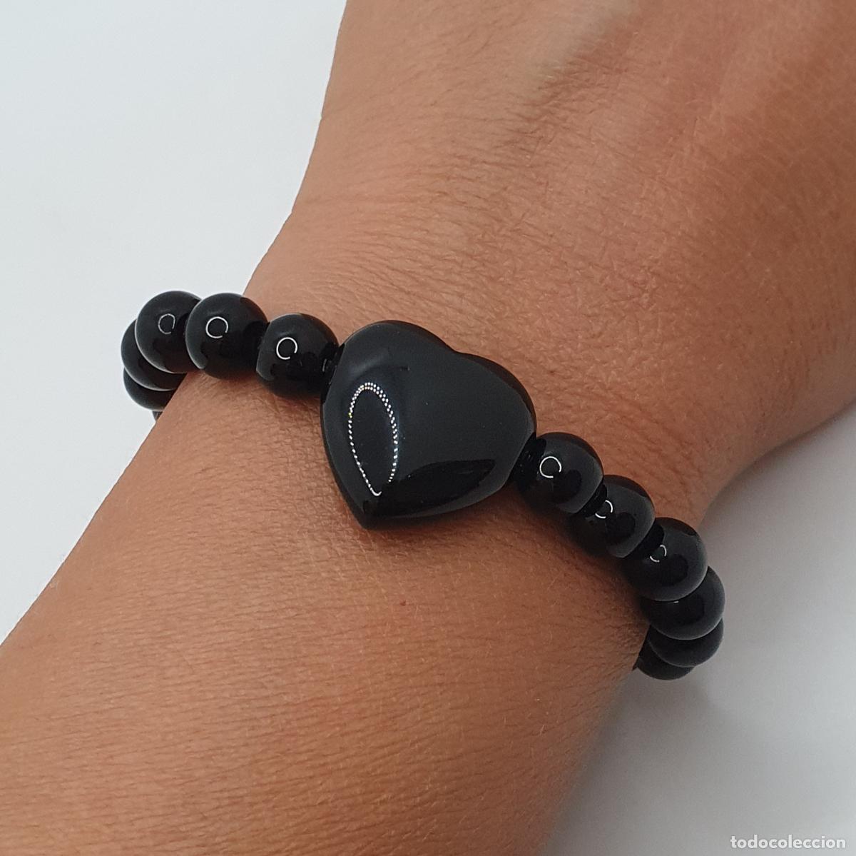 Joyeria: Excelente pulsera en esferas de &oacute;nix negro con bello coraz&oacute;n central, piedra de la protecci&oacute;n.