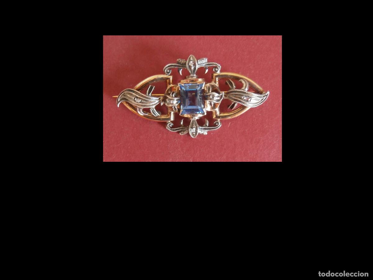 Joyeria: Broche con marquesitas y piedra azul lineas doradas