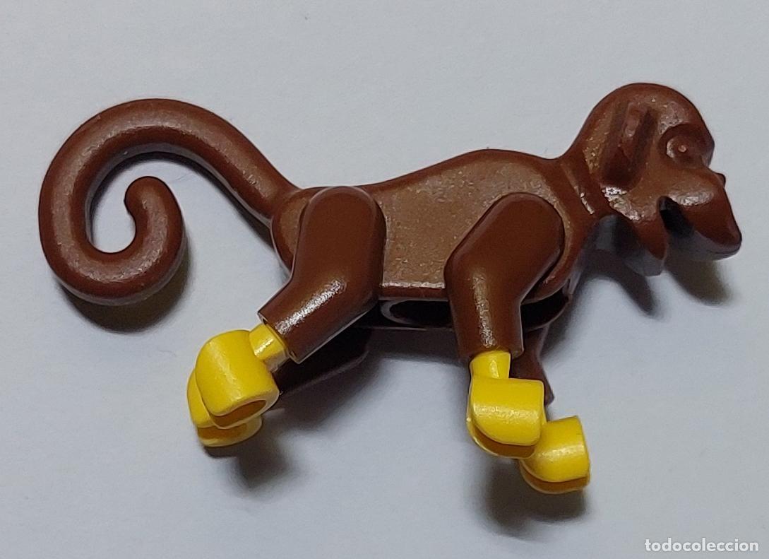 Juegos construcci&oacute;n - Lego: Original LEGO - Un mono marr&oacute;n con brazos y piernas de color amarillo brillante.