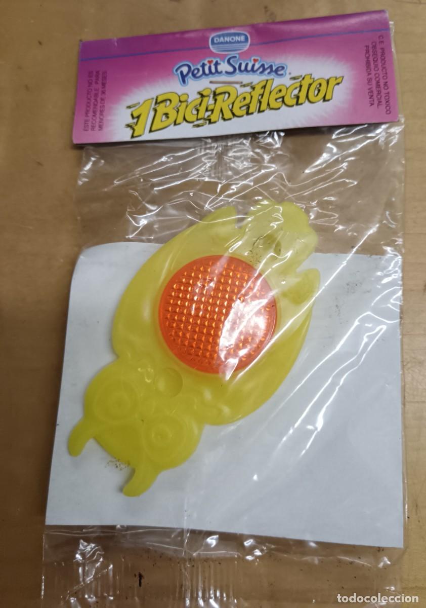 Juguetes antiguos y Juegos de colecci&oacute;n: BICI-REFLECTOR B&Uacute;HO AMARILLO PETIT SUISSE DANONE SIN ABRIR