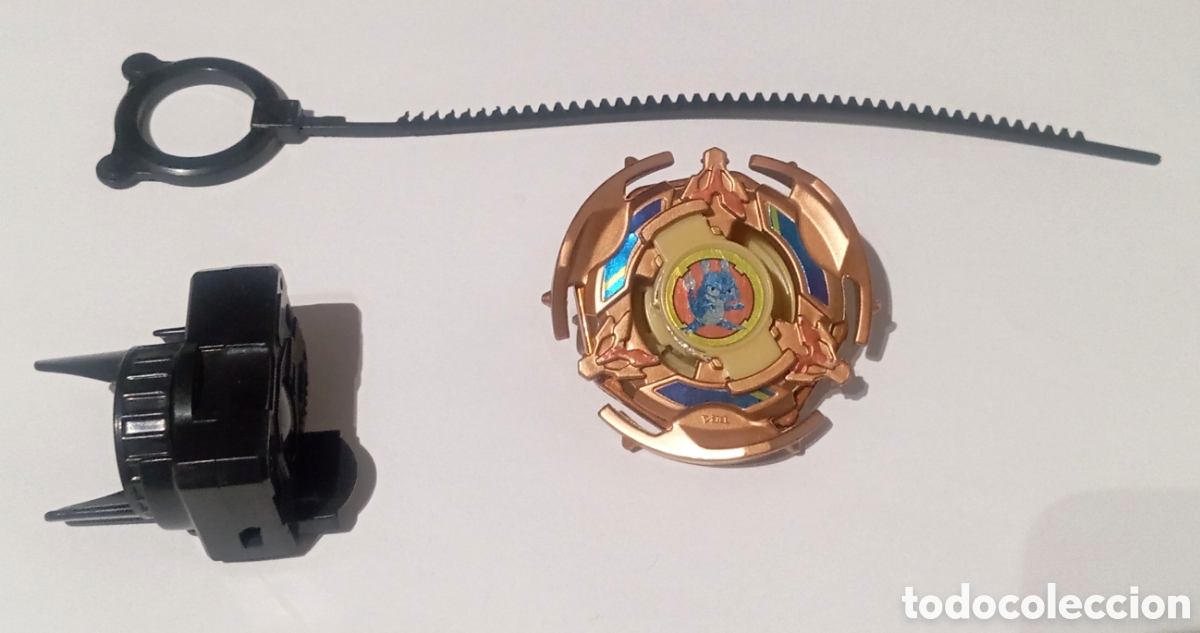 Juguetes antiguos y juegos de colecci&oacute;n: Beyblade peonza con lanzador Bronze Kid Dragoon