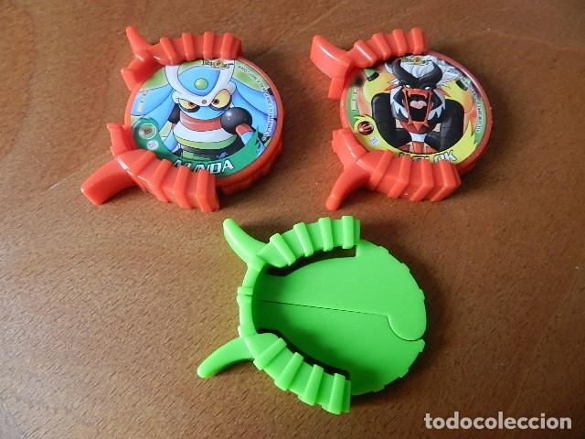Juguetes antiguos y juegos de colecci&oacute;n: Lote 2 TAZO y lanzadores MAGIC BOX INT. HEROES LEGEND OF THE BATTLE DISKS DISCO N&ordm; 21 NUNDA 31 WOLOK