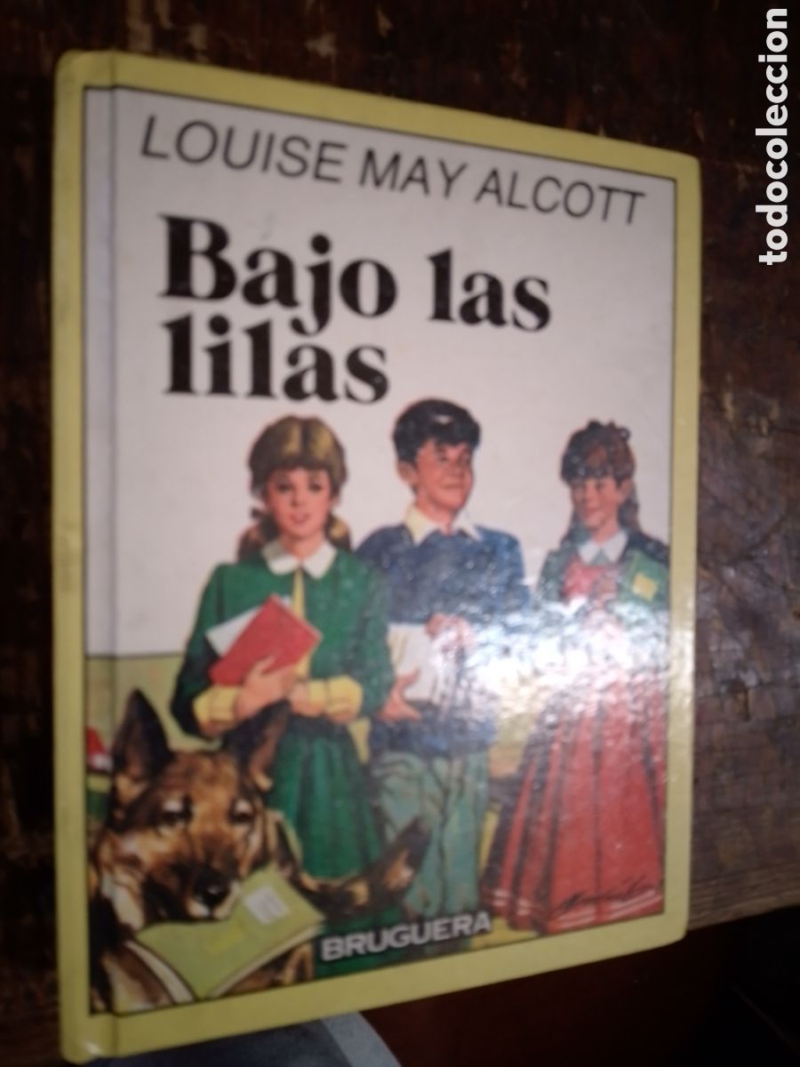 Libros de segunda mano: BAJO LAS LILAS. MAY ALCOTT, LOUISE. BRUGUERA. 1986