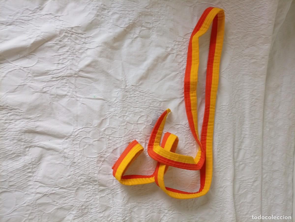 Coleccionismo deportivo: cintur&oacute;n de artes marciales de color amarillo y naranja usado com&uacute;nmente en disciplinas como judo,