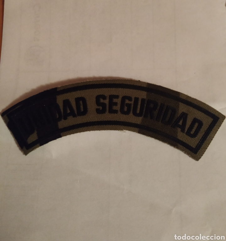 Militaria: PARCHE EMBLEMA TIRA UNIDAD SEGURIDAD CAMUFLAJE