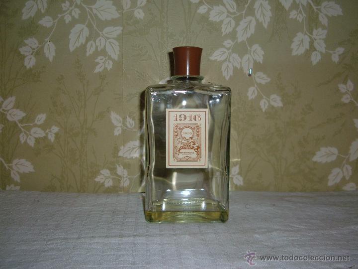 Miniaturas de perfumes antiguos: Botella de Colonia 1916 con tapon de bacalita altura 22,5 cm