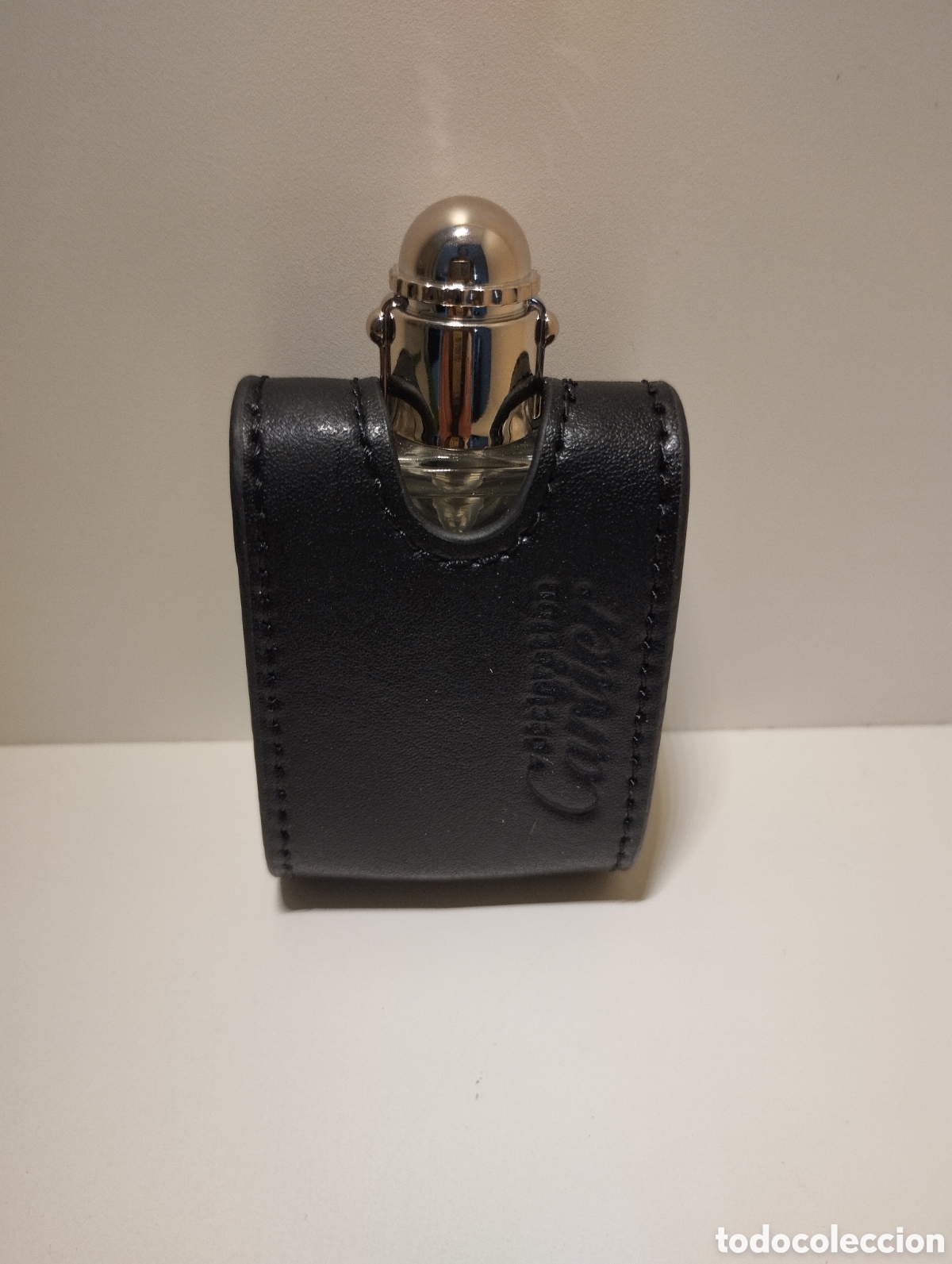 Miniaturas de perfumes antigos: Declaration Cartier EDT con funda de cuero