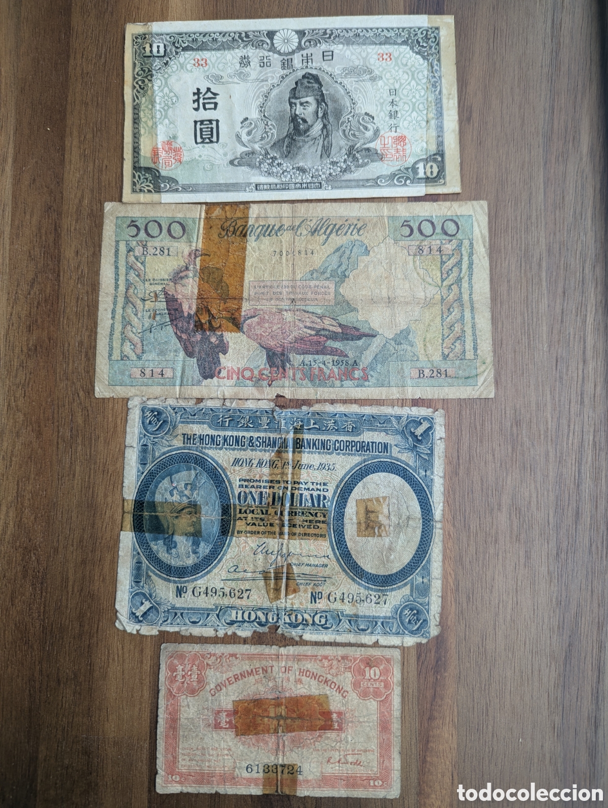 Monete antiche di Asia: Billetes escasos con reparaciones &ndash; Argelia 500 francos 1958 y HSBC Hong Kong 1 d&oacute;lar 1935