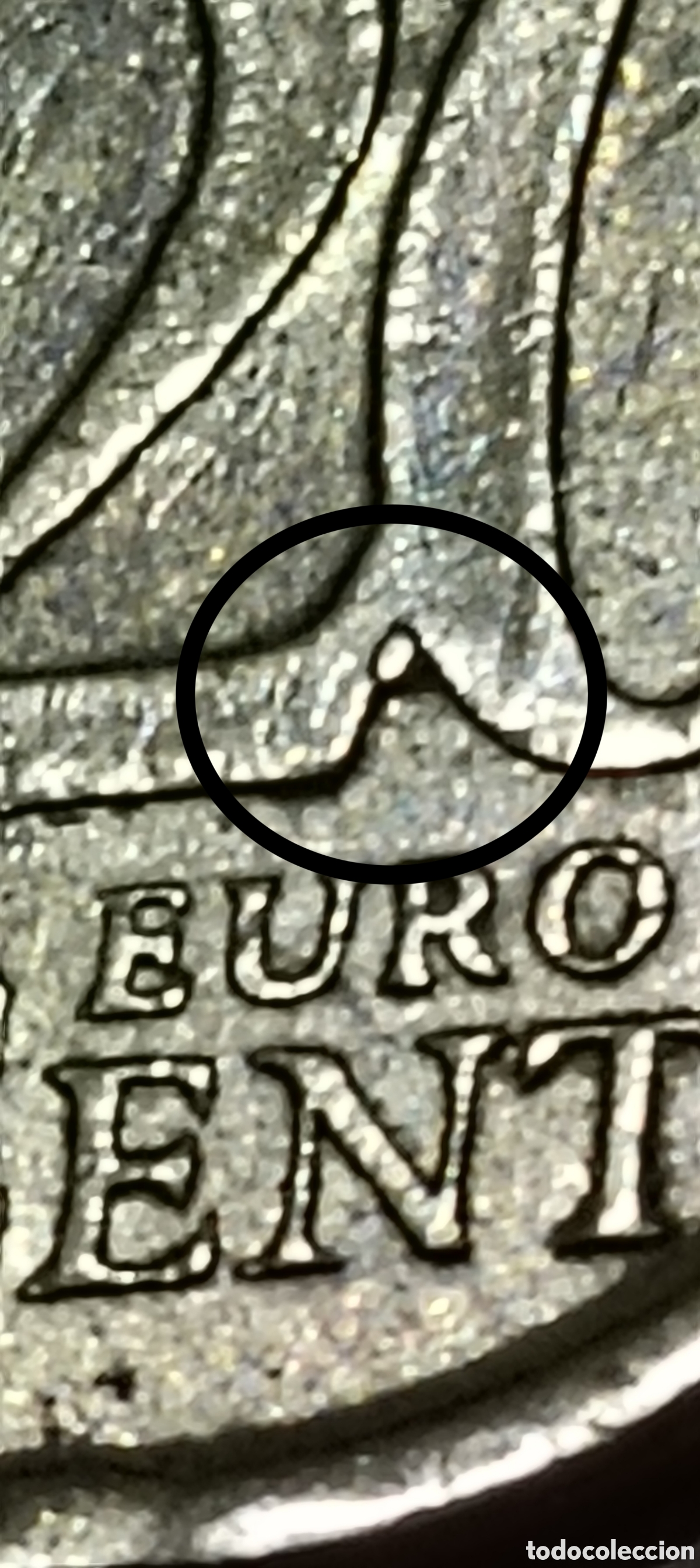 Monedas con errores: AF. 20 cts. 1999. Espa&ntilde;a. Pegote de metal entre el 2 y el 0 del reverso.