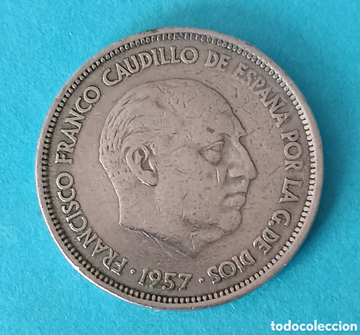 Monete Franco: 25 Pesetas Franco 1957 *64 con error de acu&ntilde;aci&oacute;n.