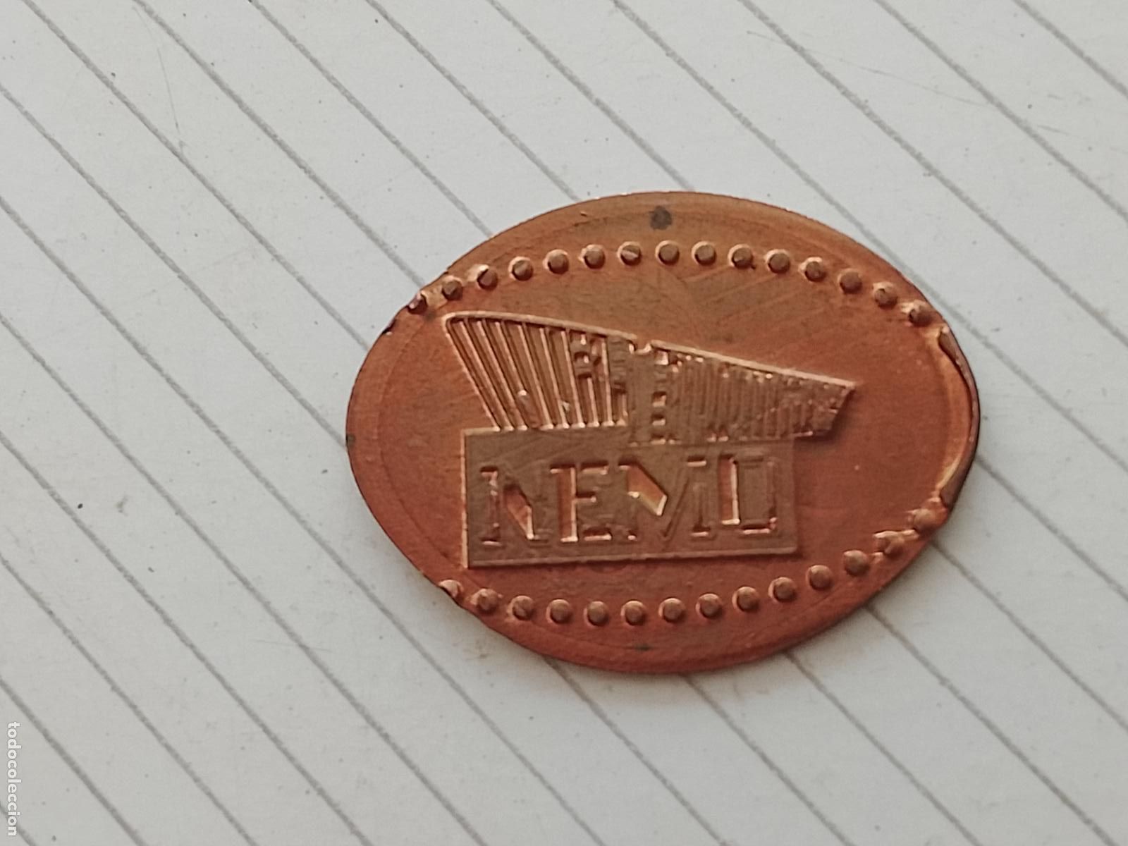 Monedas locales: Token / ficha enlongada. NEMO