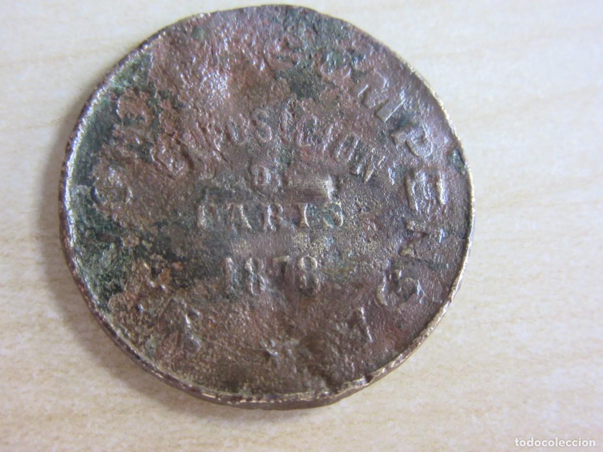 Monnaies locales: Curiosa ficha comercial de Ginebra La Llave emitida con motivo Exposici&oacute;n Universal Par&iacute;s 1878 D 2,8
