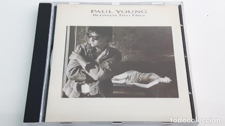 CDs de m&uacute;sica: CD PAUL YOUNG - BETWEEN TWO FIRES - Foto 1