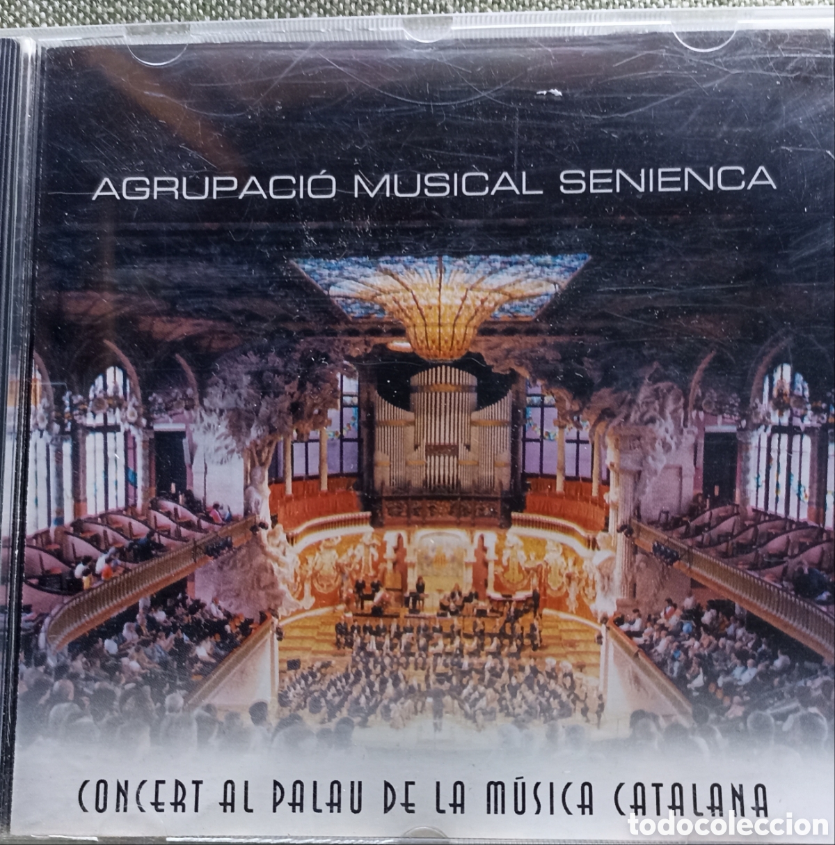 CDs de M&uacute;sica: Concert al Palau de la M&uacute;sica Catalana&rdquo; de la Agrupaci&oacute; Musical Senienca, publicado originalmente