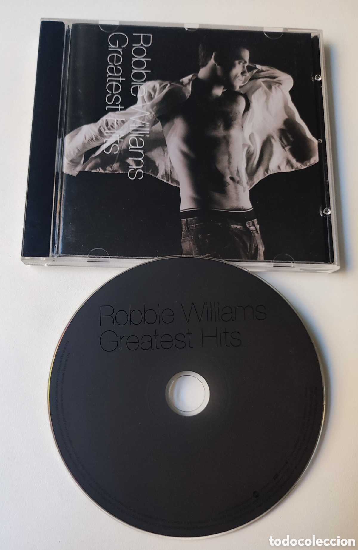 CDs de m&uacute;sica: ROBBIE WILLIAMS / GREATEST HITS - LIBRO DE FOTOS + CD / 2004 CHRYSALIS