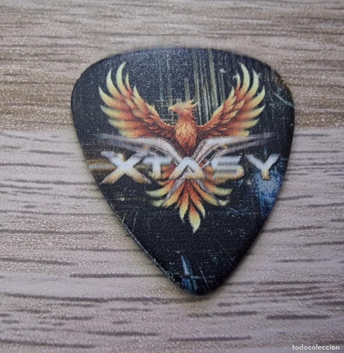M&uacute;sica de colecci&oacute;n: XTASY PUA/GUITAR PICK LOGO PHOENIX 2026 JORGE OLLOQUI