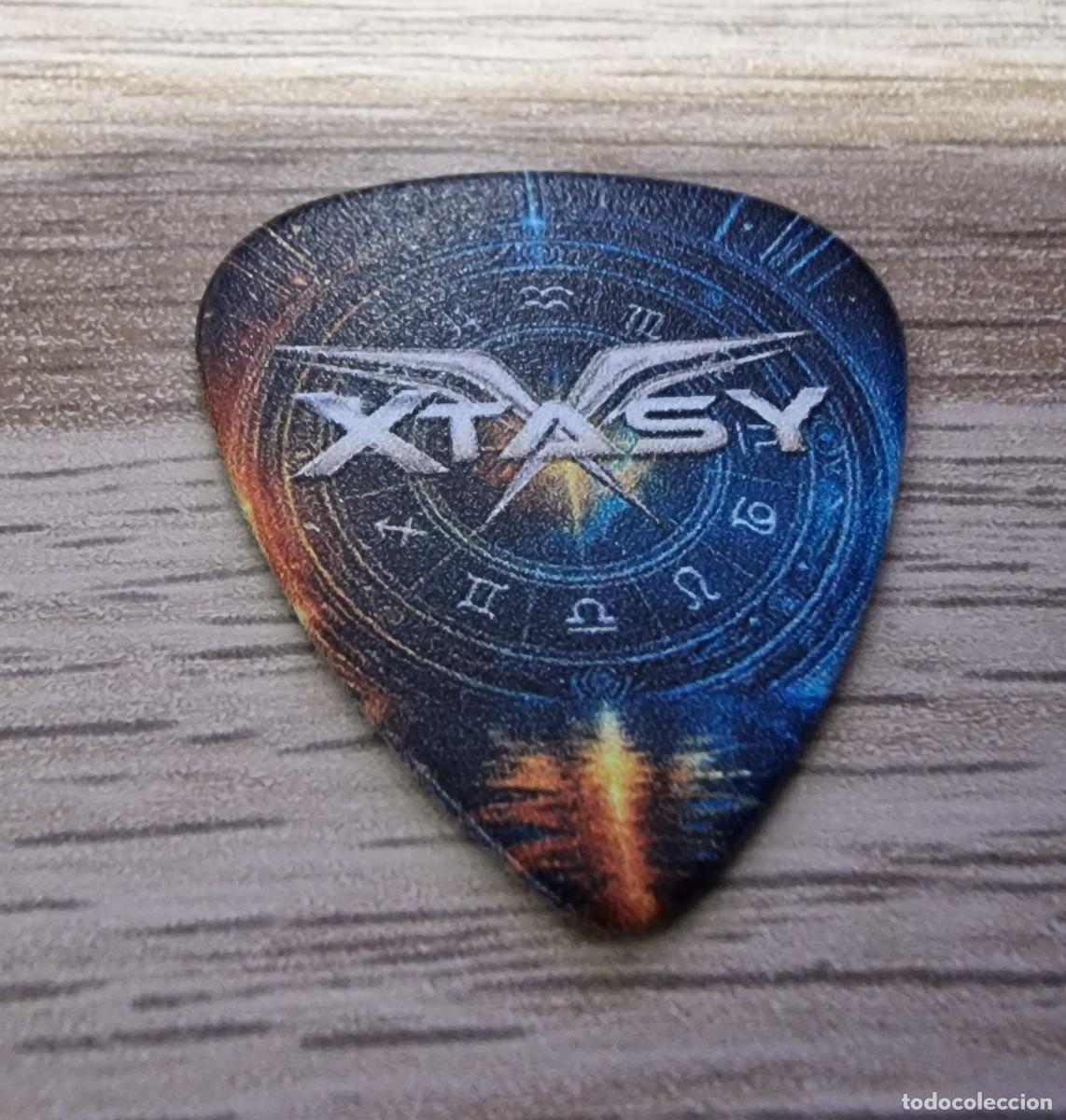 M&uacute;sica de colecci&oacute;n: XTASY PUA/GUITAR PICK LOGO 2026 JORGE OLLOQUI