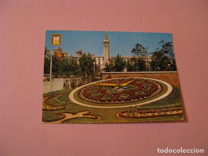 Postales: POSTAL DE CADIZ. RELOJ DE FLORES Y MONUMENTO A LAS CORTES. ED. SUBIRATS CASANOVAS. CIRCULADA 1964.