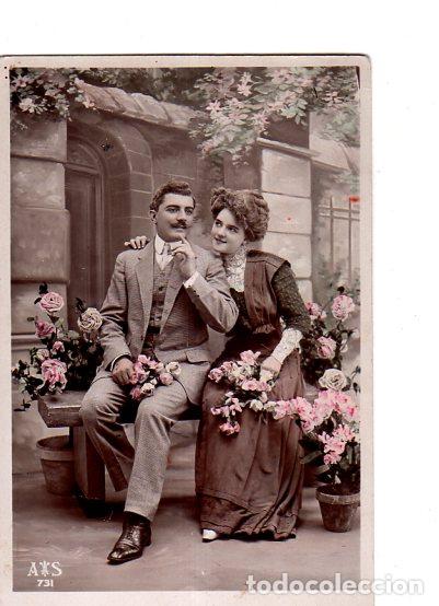 Postais: TARJETA POSTAL DE GALANTES Y MUJERES. PAREJA SENTADA EN UN BANCO RODEADOS DE FLORES.