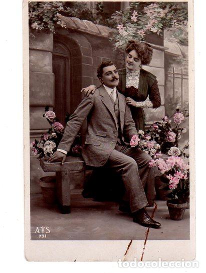 Postais: TARJETA POSTAL DE GALANTES Y MUJERES. PAREJA SENTADA EN UN BANCO RODEADO DE FLORES.