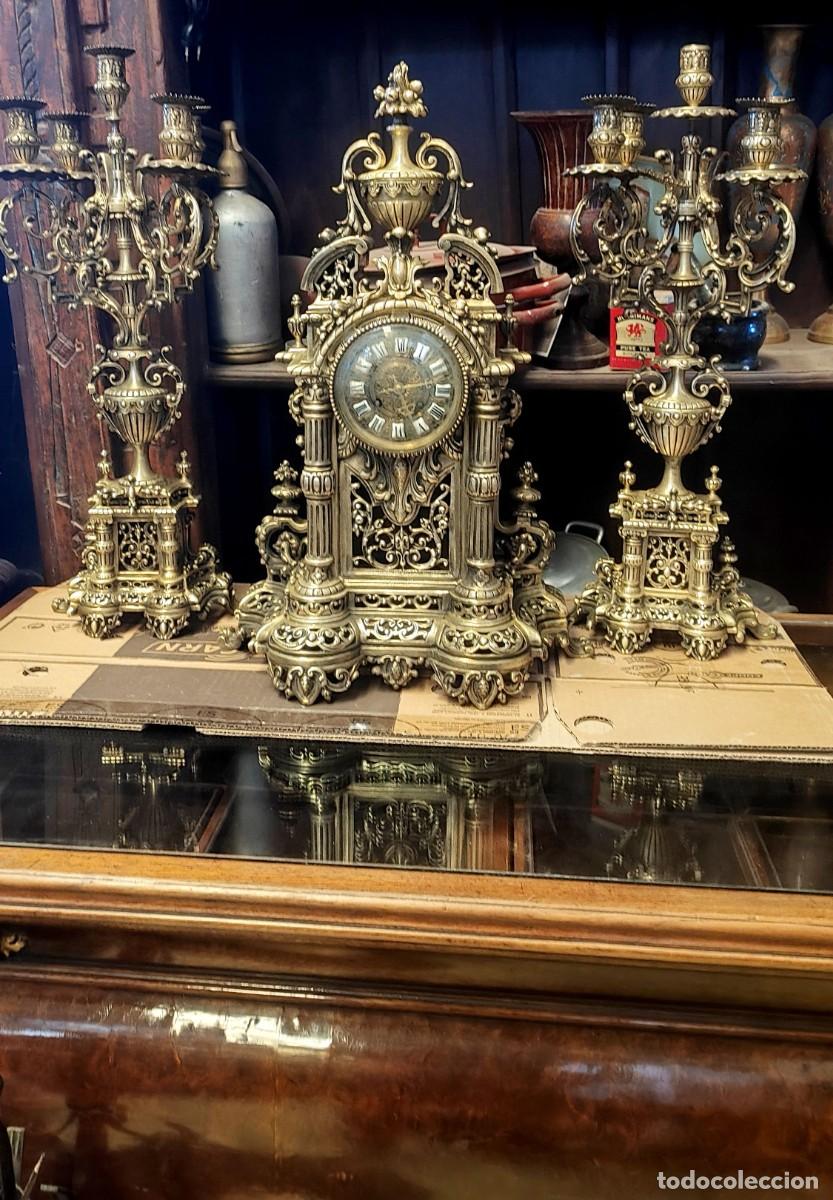 Relojes de carga manual: Guarnicion de reloj y candelabros en bronce con motivos vegetales, rocallas y columnas
