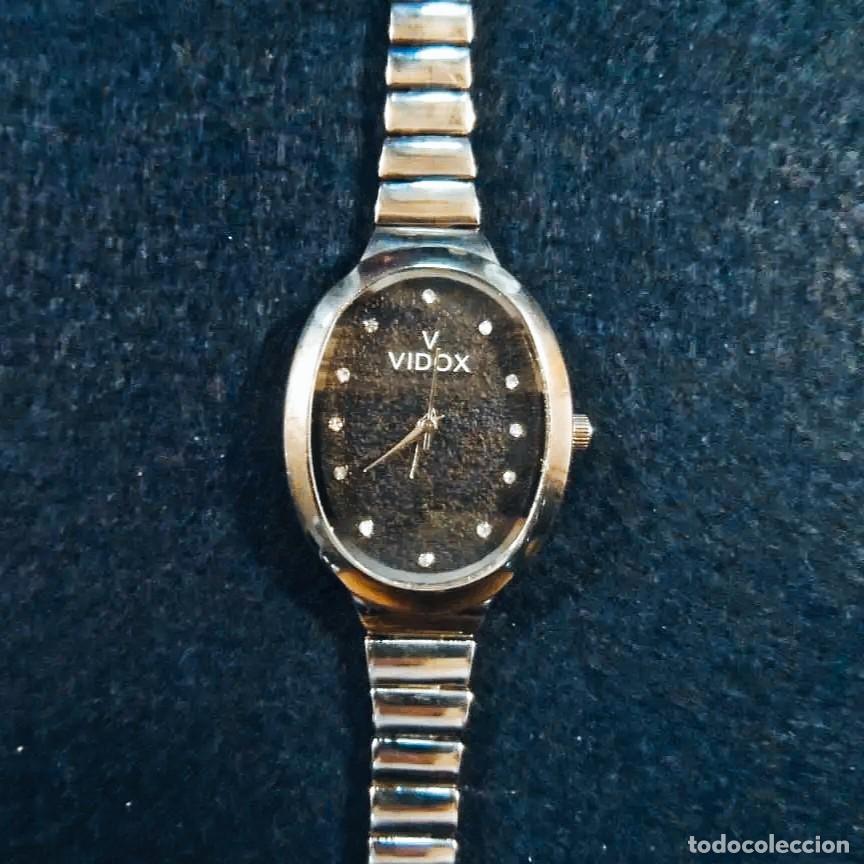 Relojes: RELOJ CON ARMIS Y CAJA DE ACERO. MARCA VIDOX. ESFERA OVAL NEGRA CON PIEDRAS. QUARTZ
