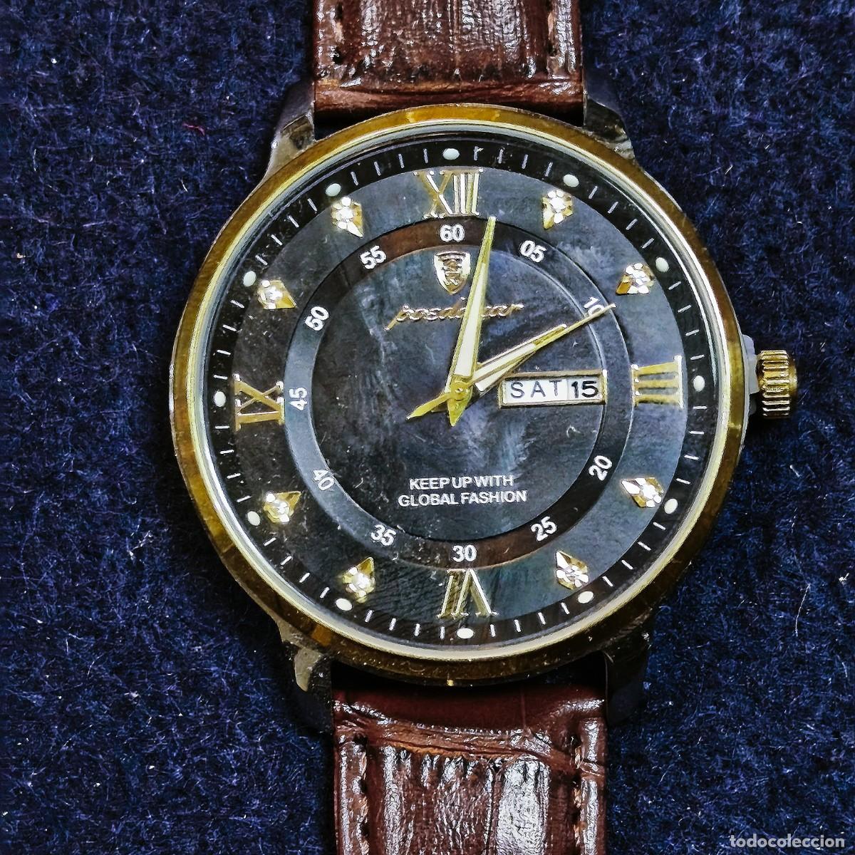 Relojes: RELOJ CORREA DE CUERO MARRON CAJA ACERO - DORADO. MARCA POCDAGAR. ESFERA NEGRA.QUARTZ