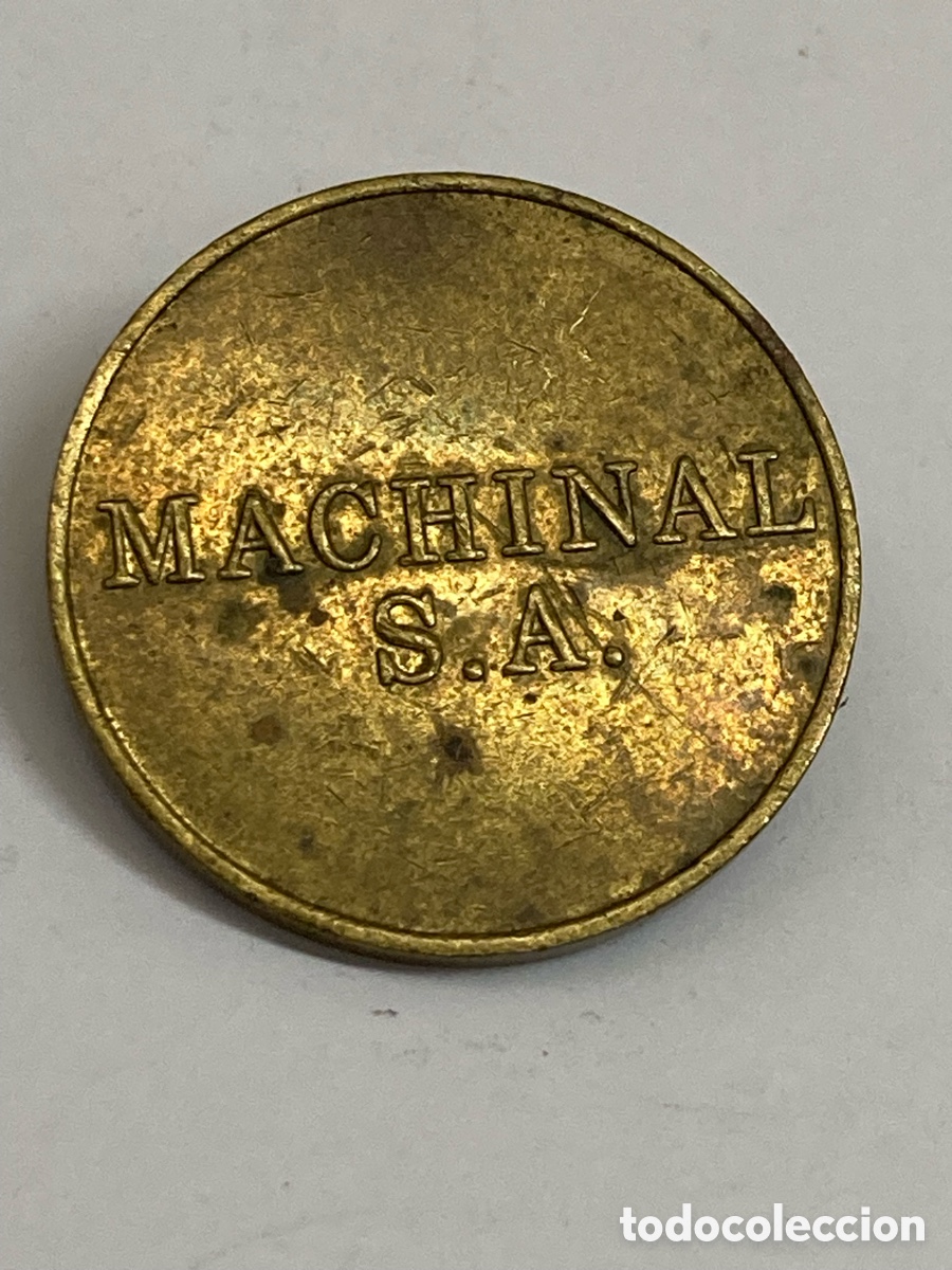 Reproducciones billetes y monedas: ficha de lat&oacute;n es una antigua ficha de m&aacute;quina