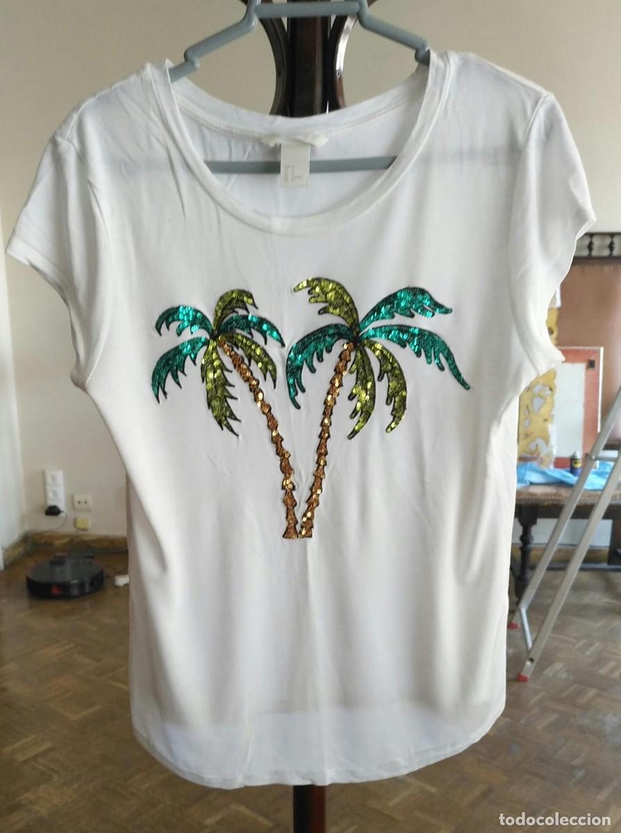 Segunda Mano: Rb 212 Camisa manga ca&iacute;da HM - T M - con Palmera de lentejuelas sobre tela blanca