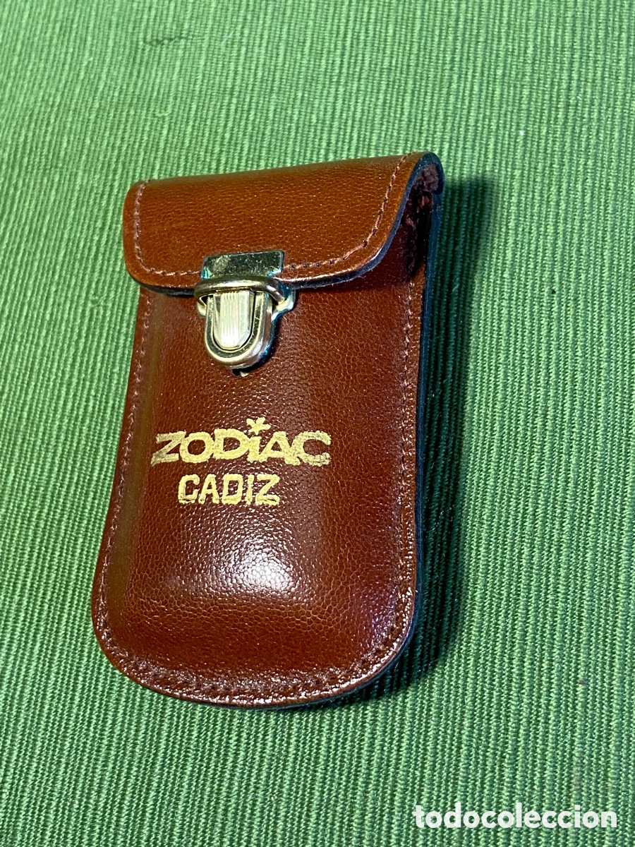 Segunda mano: Peque&ntilde;a funda publicitaria Zodiac, en piel. C&aacute;diz.