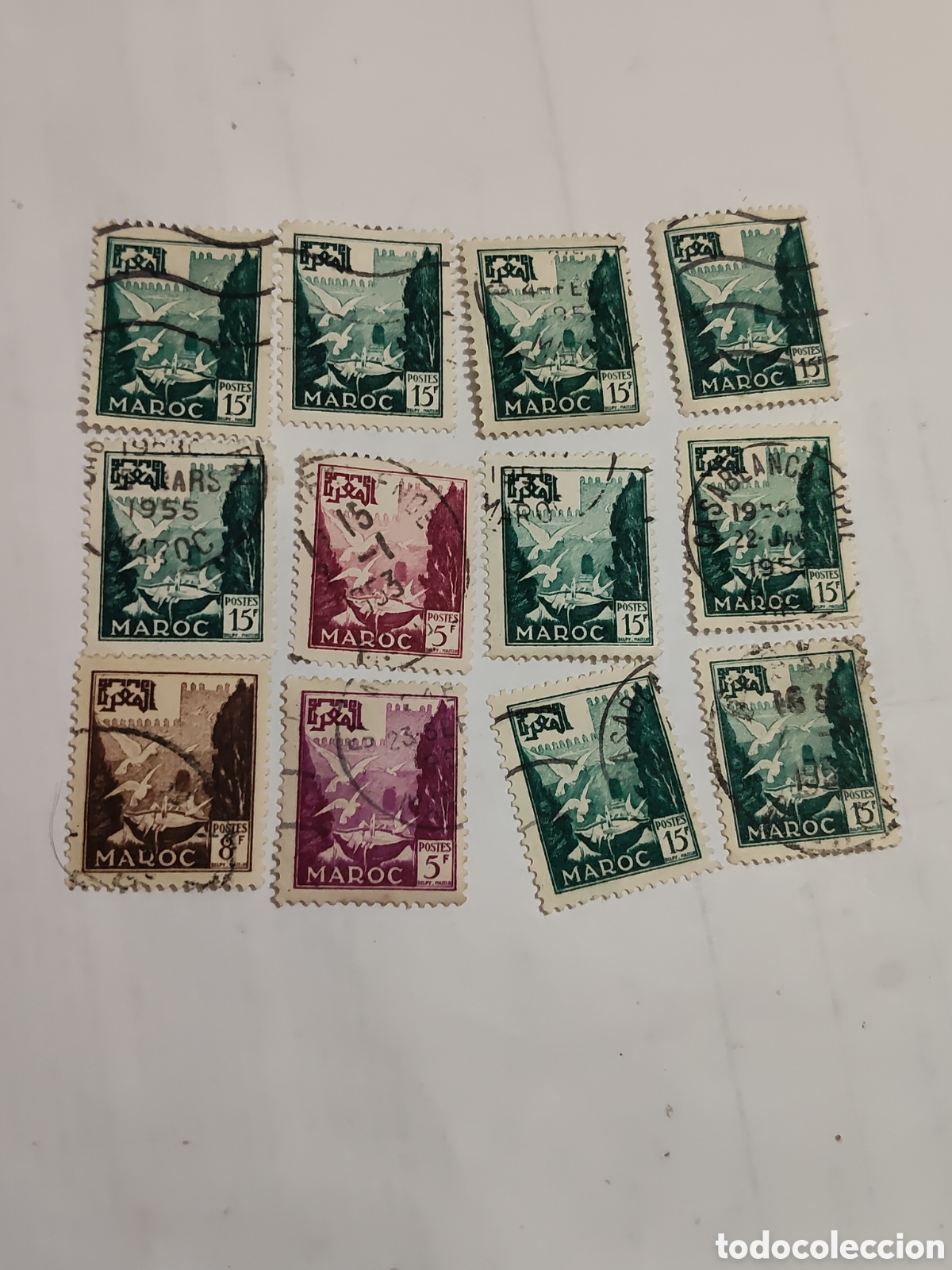 Sellos: 12 sellos de Marruecos Pil&oacute;n de la fuente con palomas 1951-54