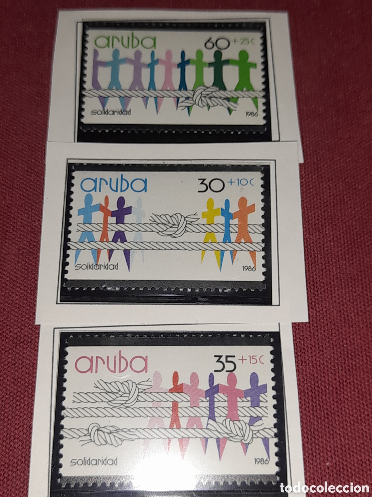 Sellos: Sello Aruba nuevo 1986. Solidaridad. Gente. Cuerdas. Interpretaci&oacute;n. Figuras estilizadas.