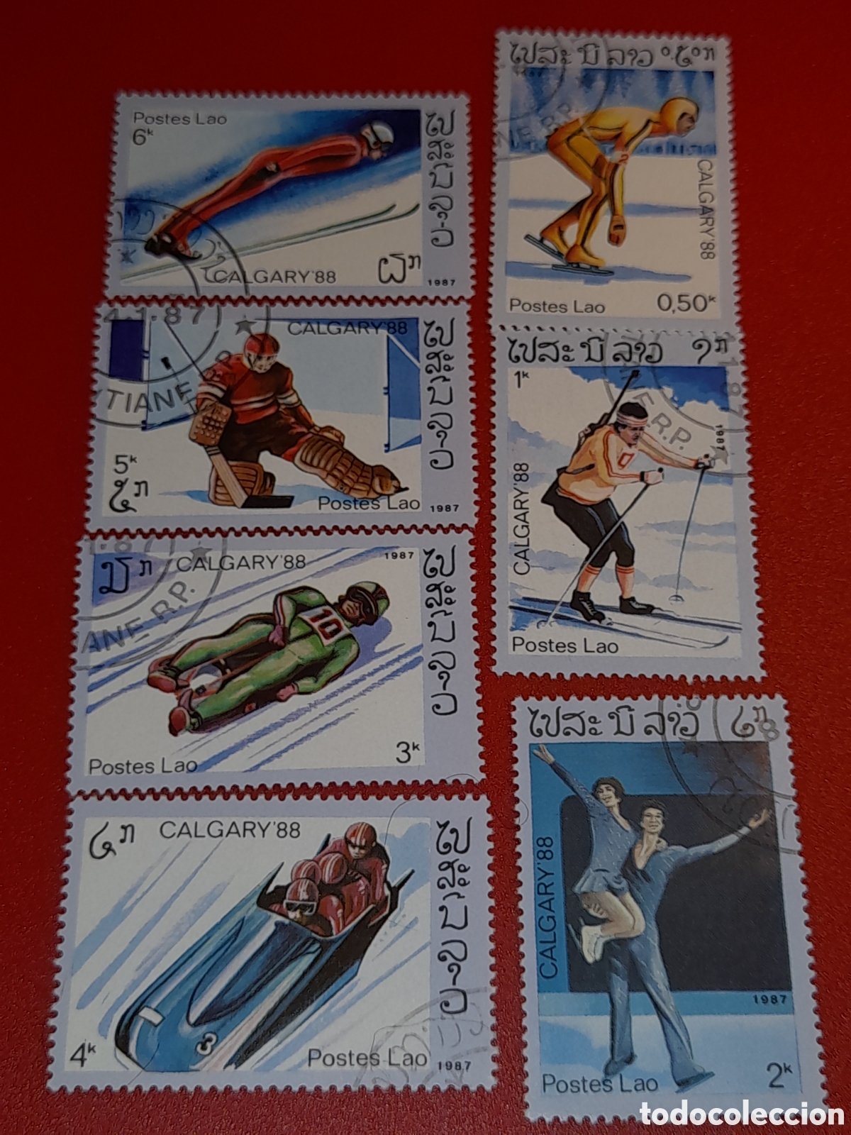 Sellos: Sello Laos mtdo 1987. Juegos olimpiada invierno. Calgary. Deporte. Esqu&iacute;. Hockey. Tiro. Salto