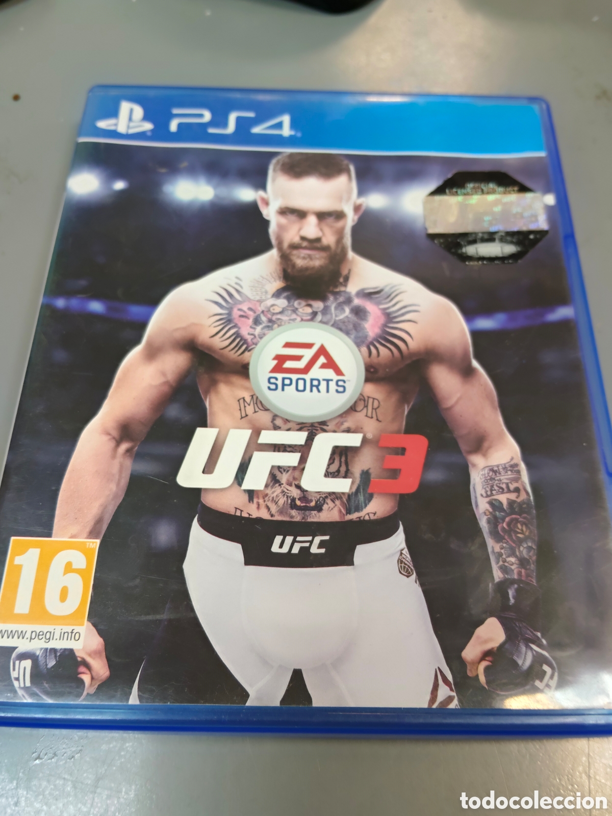Videojuegos y consolas: videojuego de lucha es EA Sports UFC 3 para la consola PlayStation 4, presentando al luchador Conor