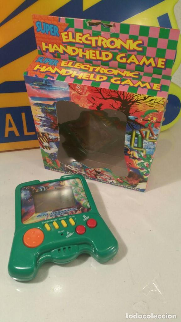 Videojuegos y consolas: ELECTRONIC HANDHELD GAME - DEVIL TERMINATOR - 9 GAMES - QGH-131 - COMO NUEVA - Foto 1