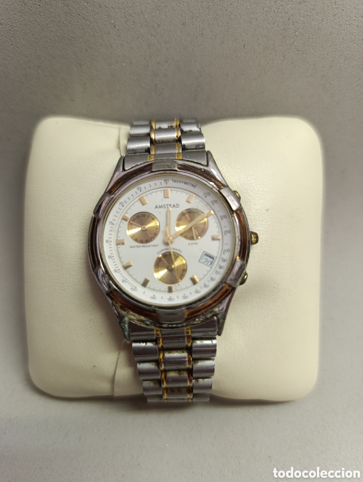 Vintage: RELOJ DE PULSERA AMSTRAD. CABALLERO. CRON CRONOMETRO. ESFERA REDONDA COLOR BLANCO. DETALLES DORADOS.