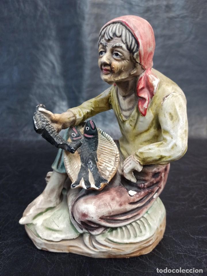 Vintage: Figura vieja con peces. C36